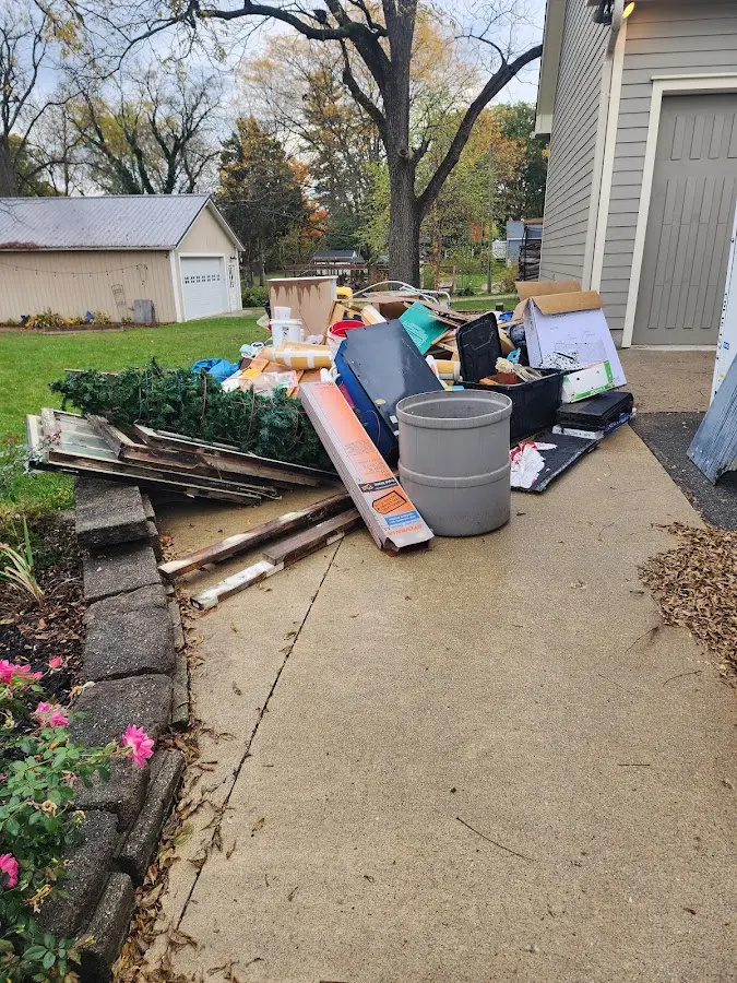 Dumpster being loaded with debris for Estate Cleanout Dumpster Rental in Willows